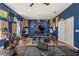 The home includes a music room with an electronic piano, guitars, wood flooring, and a ceiling fan at 6413 Emerson Rd, Brooksville, FL 34601