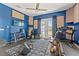 The music room has a ceiling fan, exercise equipment, soundproofing and a door leading to the outside at 6413 Emerson Rd, Brooksville, FL 34601