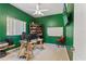 Home office with green walls, natural light, and ample desk space for productivity at 6413 Emerson Rd, Brooksville, FL 34601