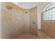 Elegant tiled shower with glass block window at 6413 Emerson Rd, Brooksville, FL 34601