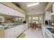 Open kitchen showcasing ample counter space, white cabinets, and a cozy breakfast nook, ideal for casual dining at 6545 Country Ridge Ln, New Port Richey, FL 34655