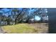 Large private backyard with mature trees and two storage sheds at 6825 Main St, New Port Richey, FL 34653
