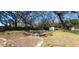 This backyard features a fire pit and large trees at 6825 Main St, New Port Richey, FL 34653