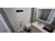 This bathroom features white cabinets and a full mirror at 6825 Main St, New Port Richey, FL 34653