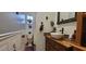 Quaint bathroom with rustic vanity, dark fixtures, and decorative accents creating a cozy, inviting space at 6825 Main St, New Port Richey, FL 34653