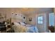 Bright bedroom with a queen-sized bed, stained glass in the door, and soft hues creating a relaxing retreat at 6825 Main St, New Port Richey, FL 34653