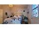 Comfortable bedroom features a decorative window and a cozy bed with floral bedding and decorative art at 6825 Main St, New Port Richey, FL 34653