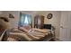 Cozy bedroom featuring a bed, wooden armoire, and a mounted television at 6825 Main St, New Port Richey, FL 34653