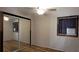 This bedroom features mirrored closets and hardwood-look floors at 6825 Main St, New Port Richey, FL 34653