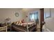 Bedroom featuring a cozy bed, side table, and natural light from the window at 6825 Main St, New Port Richey, FL 34653