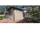 Exterior view of a shed featuring a small patio, table and chairs at 6825 Main St, New Port Richey, FL 34653