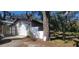 Garage exterior featuring a white door, neutral siding and a no trespassing sign out front at 6825 Main St, New Port Richey, FL 34653