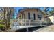 Exterior view of the house showcasing an access ramp and complementing the home's architecture at 6825 Main St, New Port Richey, FL 34653