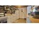 Modern kitchen featuring white cabinets, laminate countertops, and a farmhouse-style sink at 6825 Main St, New Port Richey, FL 34653