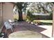 Outdoor patio perfect for entertaining with brick pavers, seating, and surrounded by lush plants and greenery at 6825 Main St, New Port Richey, FL 34653