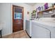 Laundry room with washer, dryer, and convenient access to the outside at 7065 Red Oak Loop, New Port Richey, FL 34654