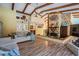 Spacious living room boasts a stone fireplace, vaulted ceilings, and exposed wood beams at 7065 Red Oak Loop, New Port Richey, FL 34654