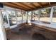 Enclosed sunroom with windows, light stained wood trim, and a stained concrete floor at 7119 Abigail Dr, Port Richey, FL 34668