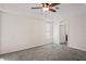 Large carpeted bedroom with natural light, ceiling fan, and en suite bathroom at 7216 Julian St, New Port Richey, FL 34653