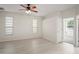 Neutral bedroom with wood-look floors, ceiling fan, and sunroom access at 7216 Julian St, New Port Richey, FL 34653