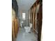 Bathroom with exposed framing next to a finished shower and toilet at 7308 Mako Dr, Hudson, FL 34667