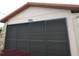 Close-up view of the garage featuring an address and a textured exterior at 7308 Mako Dr, Hudson, FL 34667