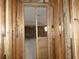 A view through the framing of a home renovation, providing a glimpse of a new layout at 7308 Mako Dr, Hudson, FL 34667