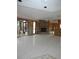 Open living space with stone fireplace and tile flooring, ready for renovation and personal touches at 7308 Mako Dr, Hudson, FL 34667