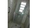 Featuring a modern shower space with glass doors, grab bars and fixtures at 7308 Mako Dr, Hudson, FL 34667