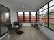 Enclosed sunroom featuring tile floors and expansive windows offering panoramic views at 7308 Mako Dr, Hudson, FL 34667