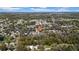 Expansive aerial view of a neighborhood surrounded by lush trees on a sunny day at 7353 Banner St, New Port Richey, FL 34653