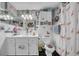 Charming bathroom featuring flamingo-themed decor, including a shower curtain and toilet seat, complemented by unique wall art at 7353 Banner St, New Port Richey, FL 34653