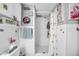 A bathroom featuring flamingo-themed decor, complemented by unique wall art and clean, tiled walls at 7353 Banner St, New Port Richey, FL 34653