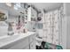 Charming bathroom featuring flamingo-themed decor, including a shower curtain and toilet seat, complemented by unique wall art at 7353 Banner St, New Port Richey, FL 34653