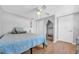 Neutral minimalist bedroom features wood floors, ceiling fan and plenty of space at 7353 Banner St, New Port Richey, FL 34653