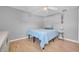 Bright, minimalist bedroom features wood floors, ceiling fan and comfortable sleeping at 7353 Banner St, New Port Richey, FL 34653