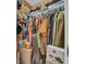 A well-organized walk-in closet with wooden walls, filled with clothes, shoes, and accessories at 7353 Banner St, New Port Richey, FL 34653