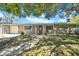 Inviting single-story home featuring a well-maintained lawn and attached garage at 7353 Banner St, New Port Richey, FL 34653