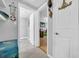 A hallway with tiled floors and doorways leading to other rooms, decorated with nautical-themed items at 7353 Banner St, New Port Richey, FL 34653