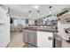 Open kitchen layout featuring a center island and view into the dining area at 7353 Banner St, New Port Richey, FL 34653