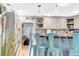 Bright eat-in kitchen with a breakfast bar, bar stool seating, and decorative overhead lighting at 7353 Banner St, New Port Richey, FL 34653