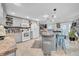 Spacious kitchen featuring gray cabinetry, modern appliances, and a breakfast bar at 7353 Banner St, New Port Richey, FL 34653