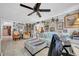 Open-concept living space with stylish nautical decor, tiled floors, and comfortable furnishings at 7353 Banner St, New Port Richey, FL 34653