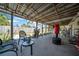 Spacious covered patio with outdoor furniture and a view of the fenced yard at 7353 Banner St, New Port Richey, FL 34653