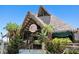Rum River Bar & Grill with tropical-themed architecture, including a thatched roof and lush landscaping at 8141 Aquila St # 334, Port Richey, FL 34668