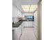 Fully-equipped kitchen featuring white cabinetry, modern appliances, and a convenient serving window at 8141 Aquila St # 334, Port Richey, FL 34668