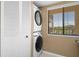 Convenient laundry area featuring stacked washer and dryer units, offering efficiency and space-saving design at 8141 Aquila St # 334, Port Richey, FL 34668