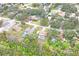 Aerial view of neighborhood with mature trees, showing homes with pools and lush greenery at 8159 Alhambra Ct, Spring Hill, FL 34606