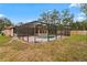 Wide outdoor shot showcases the screened-in pool and patio area with exterior of home at 8159 Alhambra Ct, Spring Hill, FL 34606