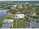 Aerial view of the community clubhouse, golf course and pool, surrounded by lush landscaping at 8910 Jericho Rd, Weeki Wachee, FL 34613